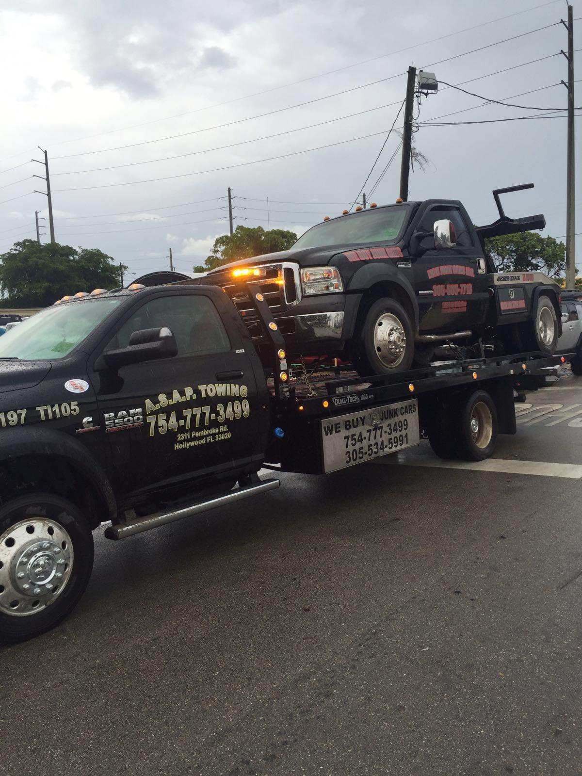 Tow truck carrying heavy car