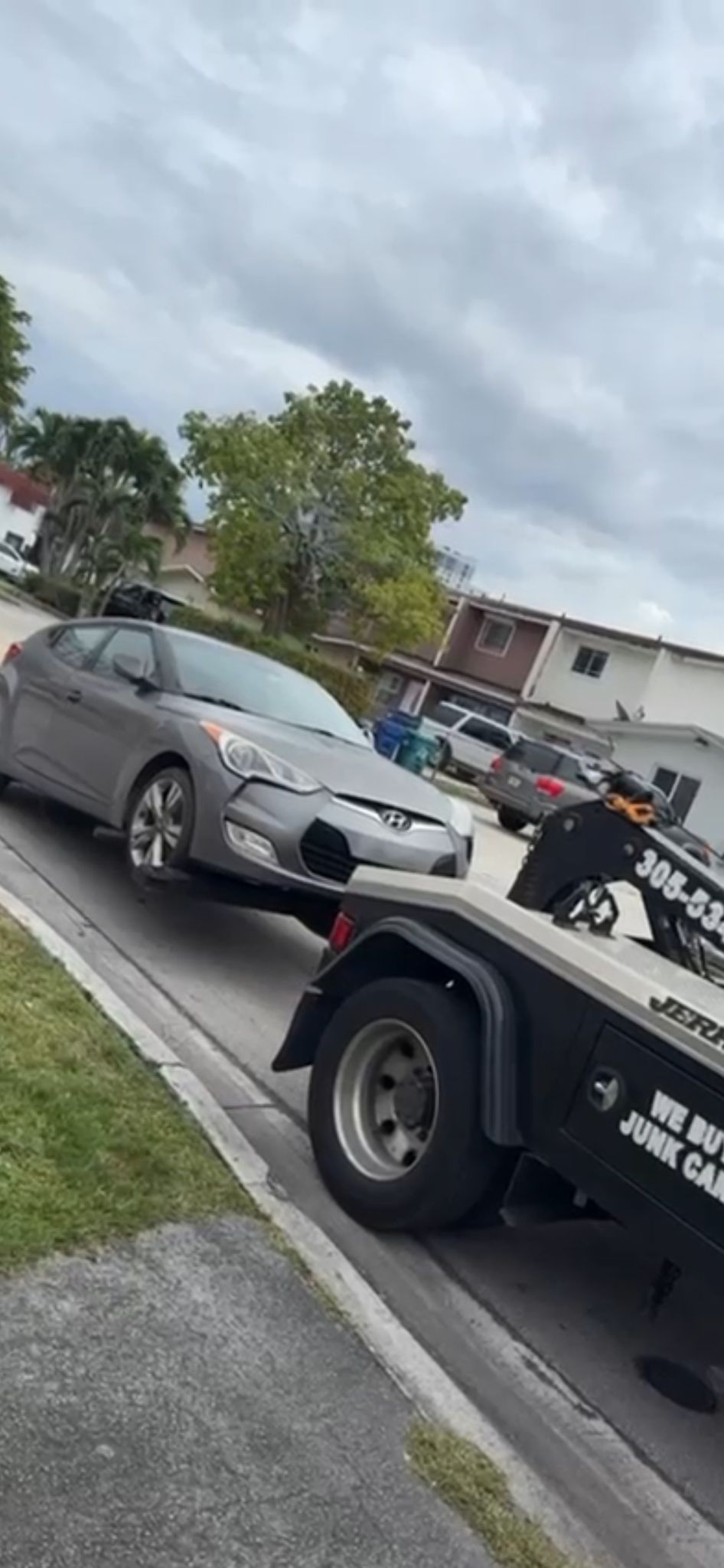 Tow truck hauling a junk car