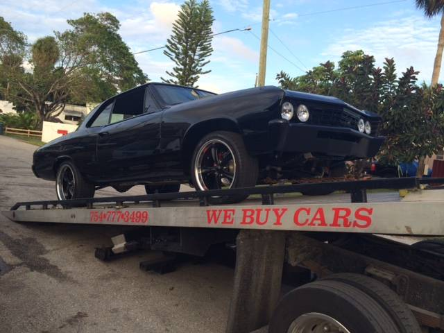 Junk car being towed